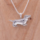 Pendentif chien en argent et pierre d'émeraude